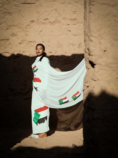 Photographer Maimana Mohammed Abbas  Bona wears Sudan flag toub by Wafaa Basan