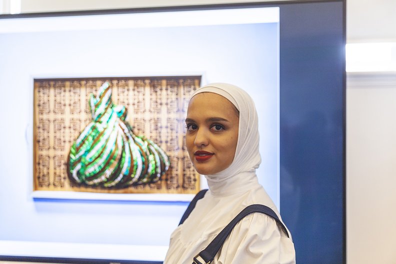 Amani Al Thuwaini at the V&A with her work displayed during LDF Victoria and Albert Museum