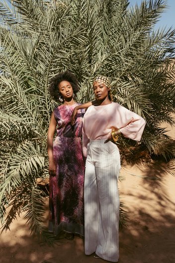 Photographer Maganga Mwango  Izy (L) wears full look by Anyango Mpinga, earrings and ring by Ashrenkail, shoes by Walaa. Bona (R) wears top by Nucy, trousers by Anyango Mpinga, bracelet by Ami Doshi Shah