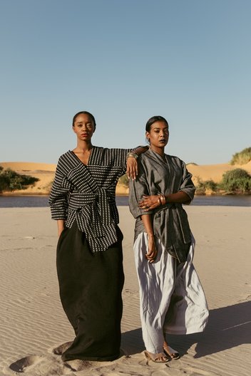 Photographer Maganga Mwango  Izy (L) wears jacket by Katungulu Mwendwa and dress by Haute Baso. Bona (R) wears jacket by Katungulu Mwendwa and culottes by Haute Baso