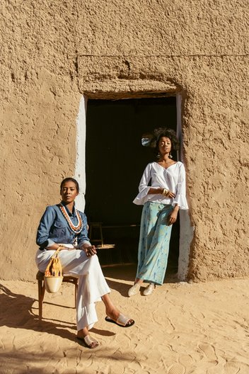 Photographer Maganga Mwango  Bona (L) wears shirt & bag by Haute Baso, trousers by Nucy and shoes by Walaa. )Izy (R) wears shirt by Boutique De Nana, trousers by Anyango Mpinga and earrings by Ami Doshi Shah 